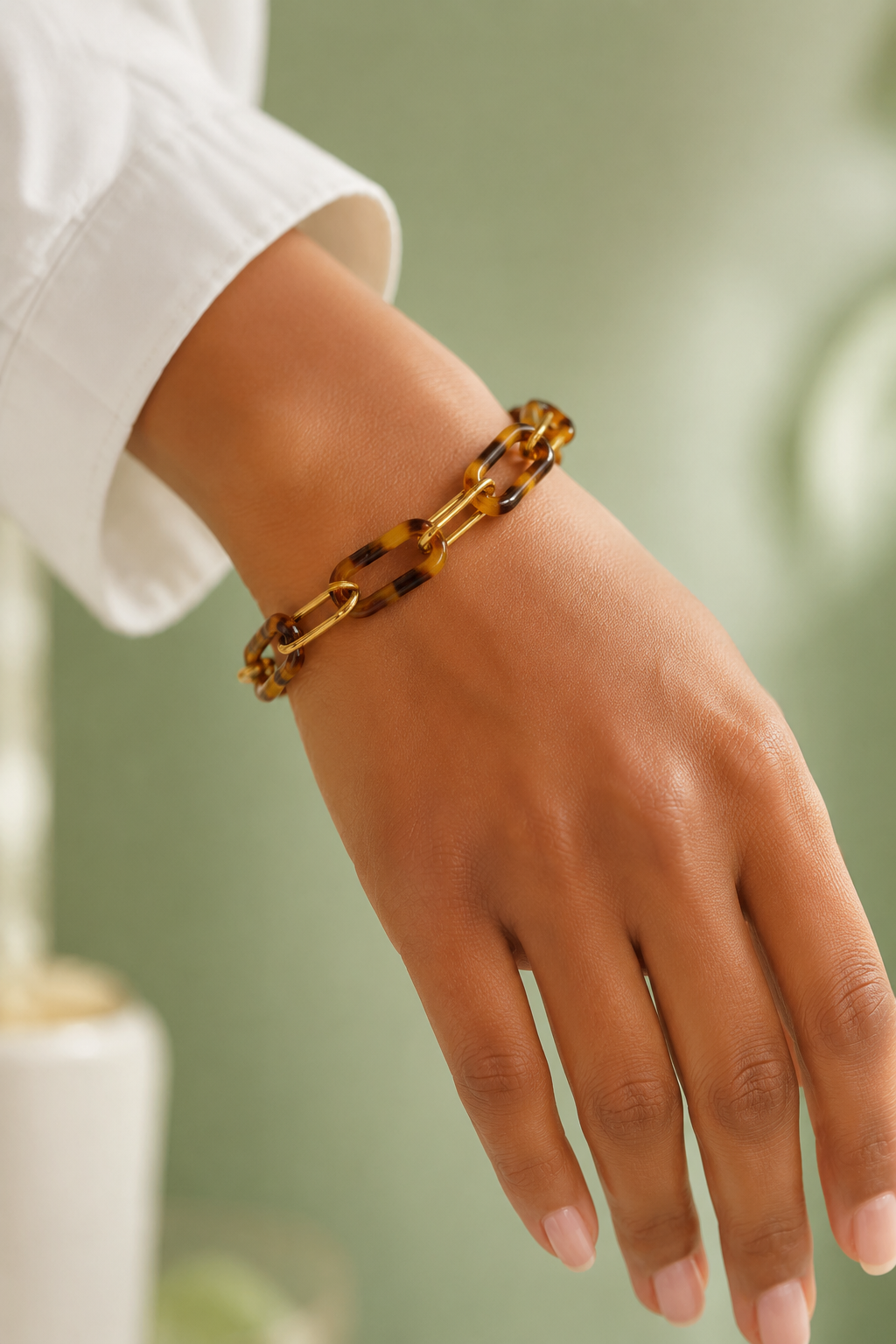 Gold Paperclip Chain and Tortoise Link Bracelet by Ali Bird worn on wrist, alternating gold paperclip and tortoise resin links
