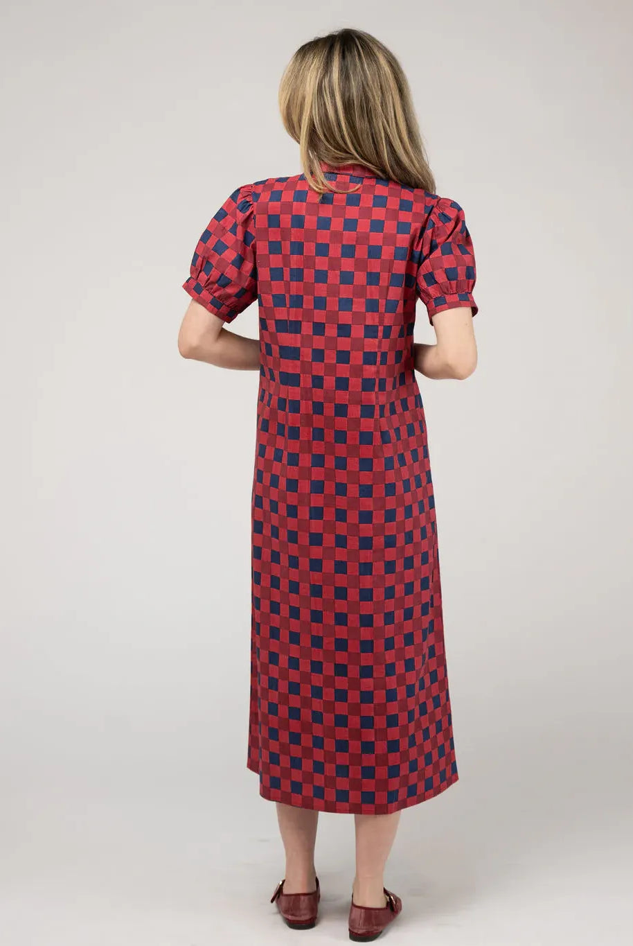 Back view of the Beau & Ro Kris Dress in cranberry check fabric, featuring a stylish and comfortable dress design.