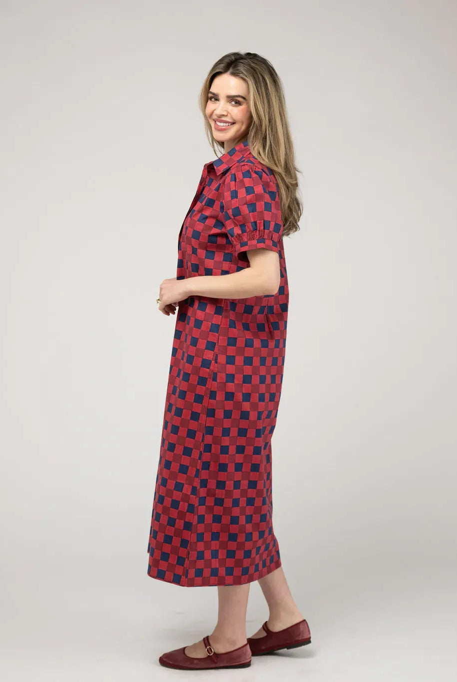 Beau & Ro Kris Cranberry Dress shown from a side view, showcasing its elegant fit and vibrant cranberry color.