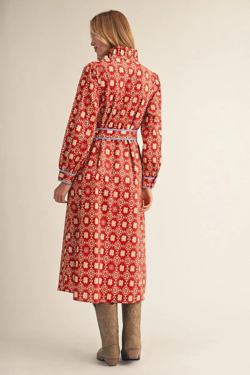 long-sleeve red midi dress with a white geometric pattern and a matching waist tie