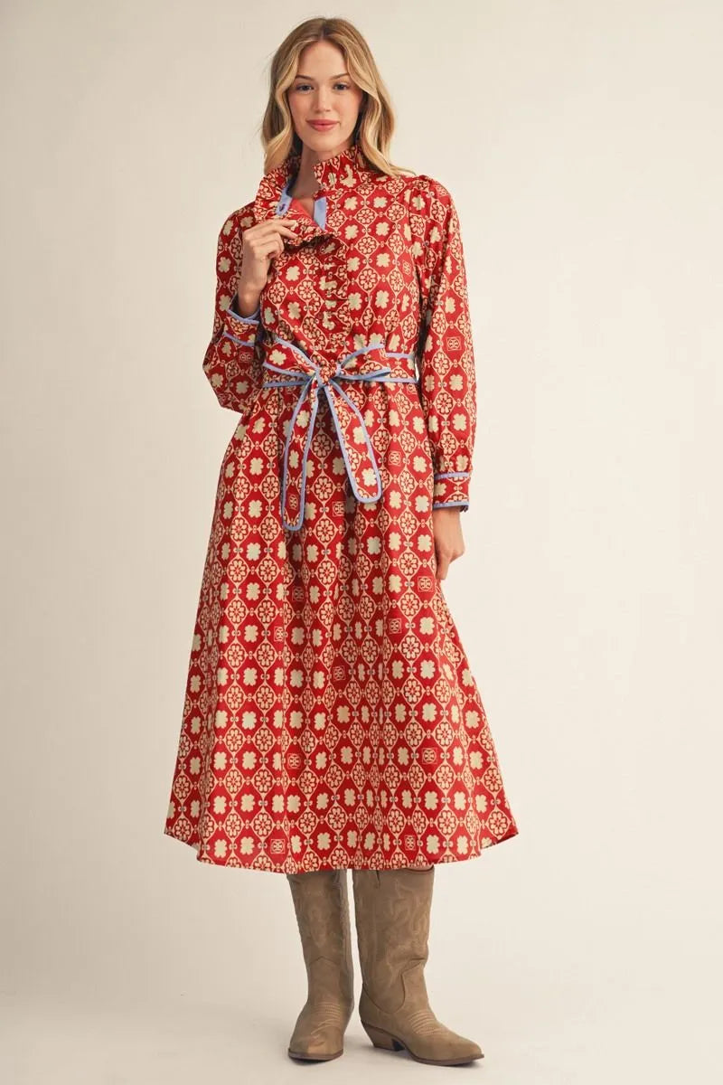 long-sleeve red midi dress with a white geometric pattern and a matching waist tie