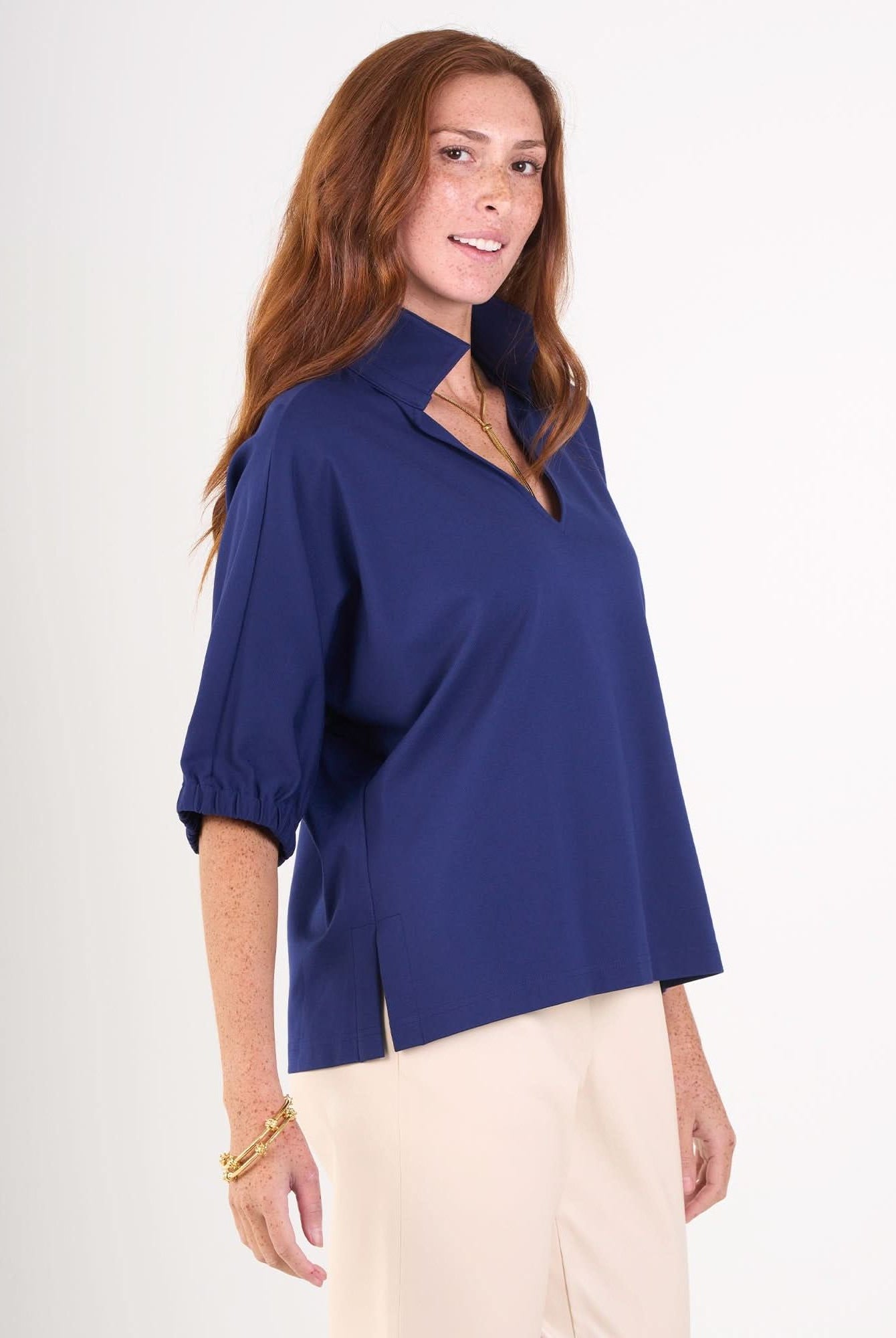 Navy Poppy Top by Emily McCarthy, made of cotton poplin, shown from the side view with a fitted silhouette and classic design.