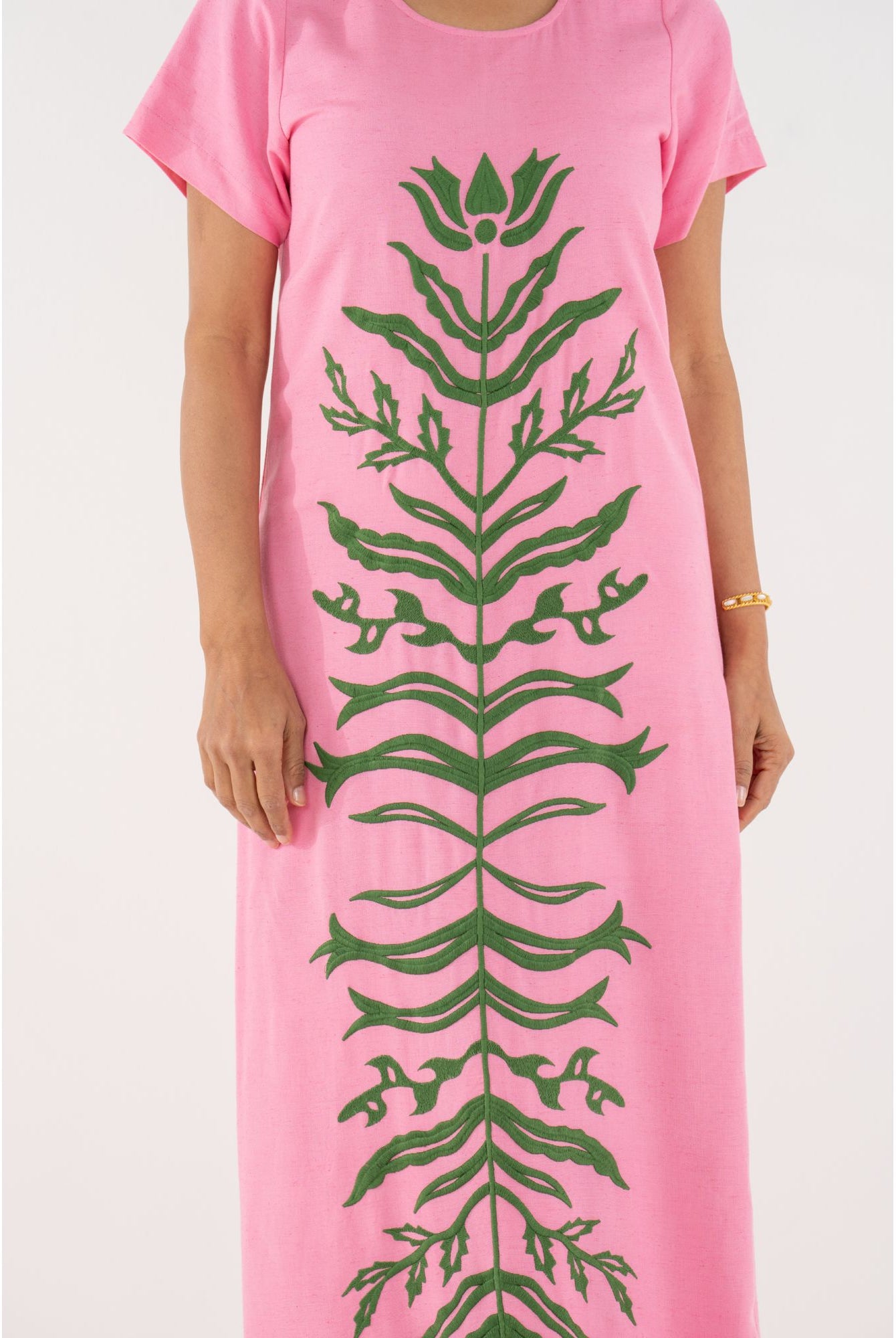 Emily McCarthy Cornelia Dress in Rose, a stylish floral dress with elegant design and vibrant pink color, displayed on a hanger.