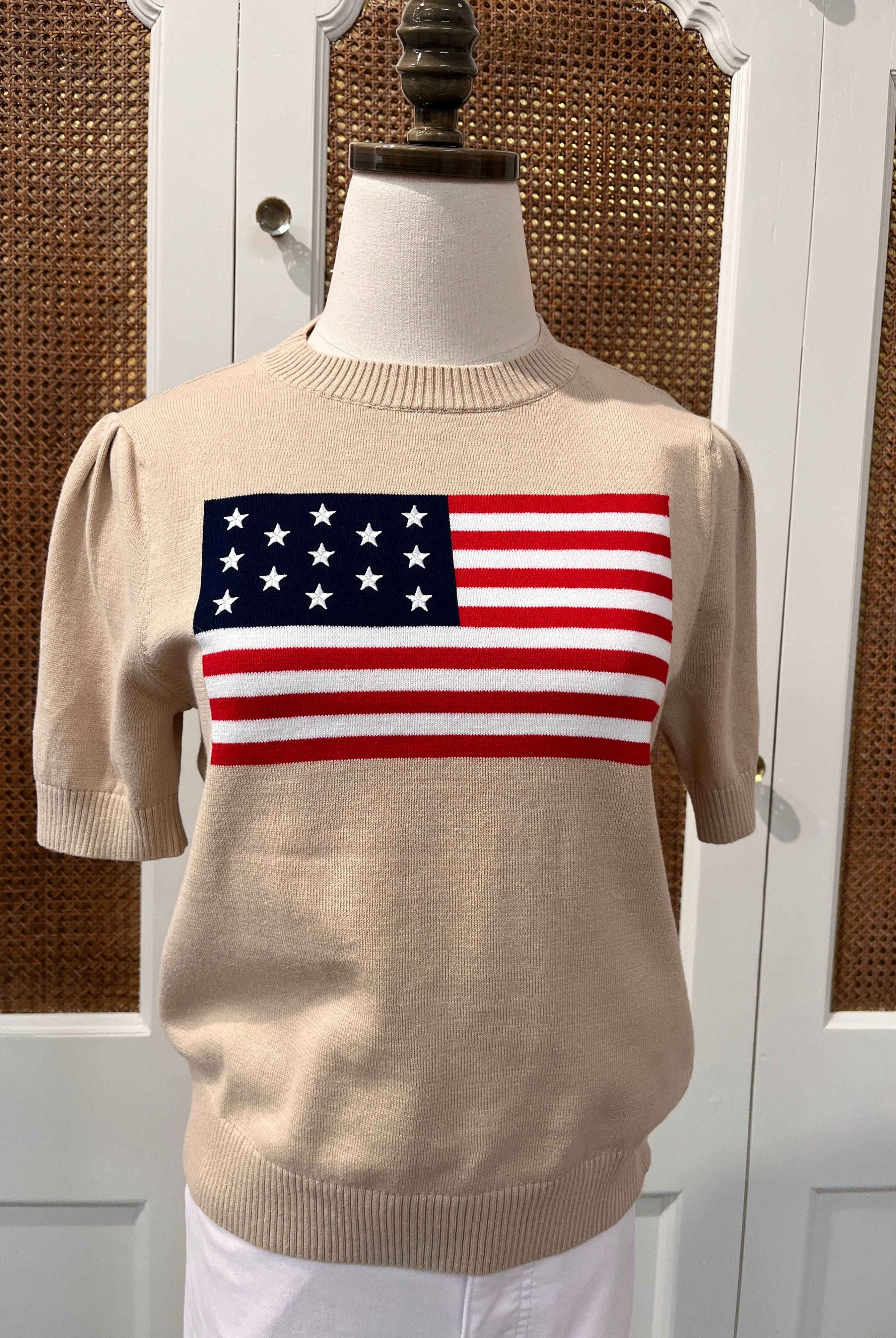 Tan puff sleeve flag sweater top by Duffield Lane, featuring bold flag print and cozy knit fabric.
