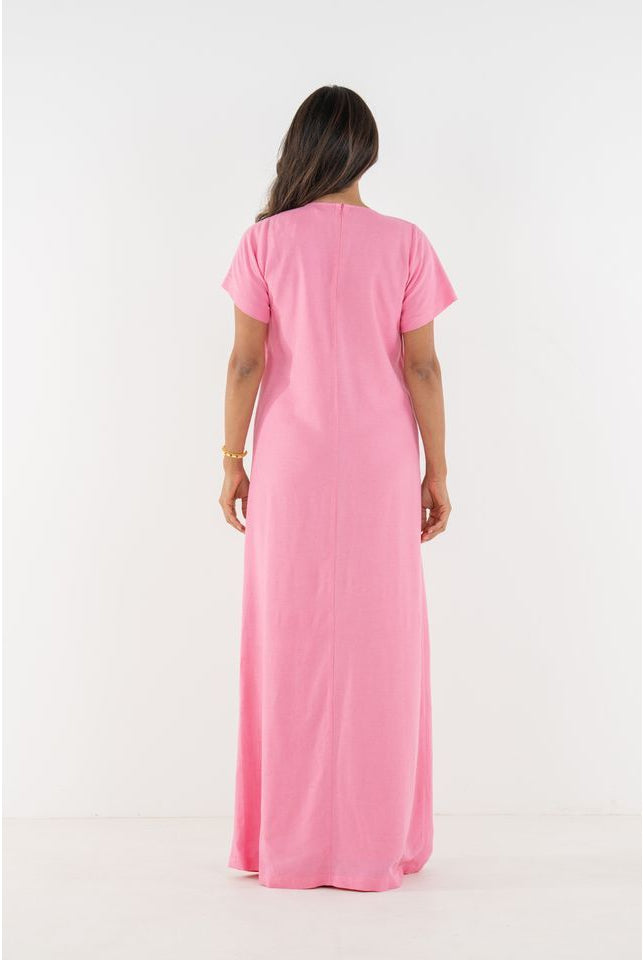 Emily McCarthy Cornelia Dress in Rose, back view showing elegant floral pattern and flowing fabric.