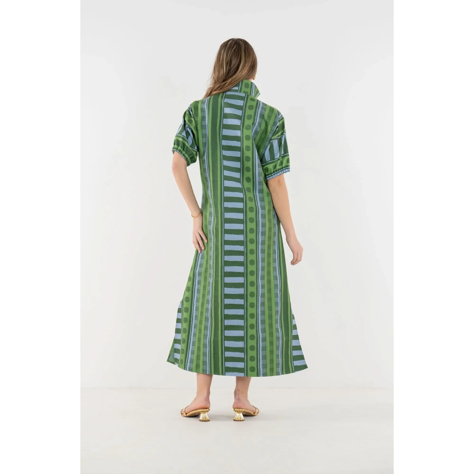Emily McCarthy Poppy Maxi Forest Jubilee dress in floral jacquard fabric, featuring a flowing silhouette and vibrant green forest-inspired pattern.