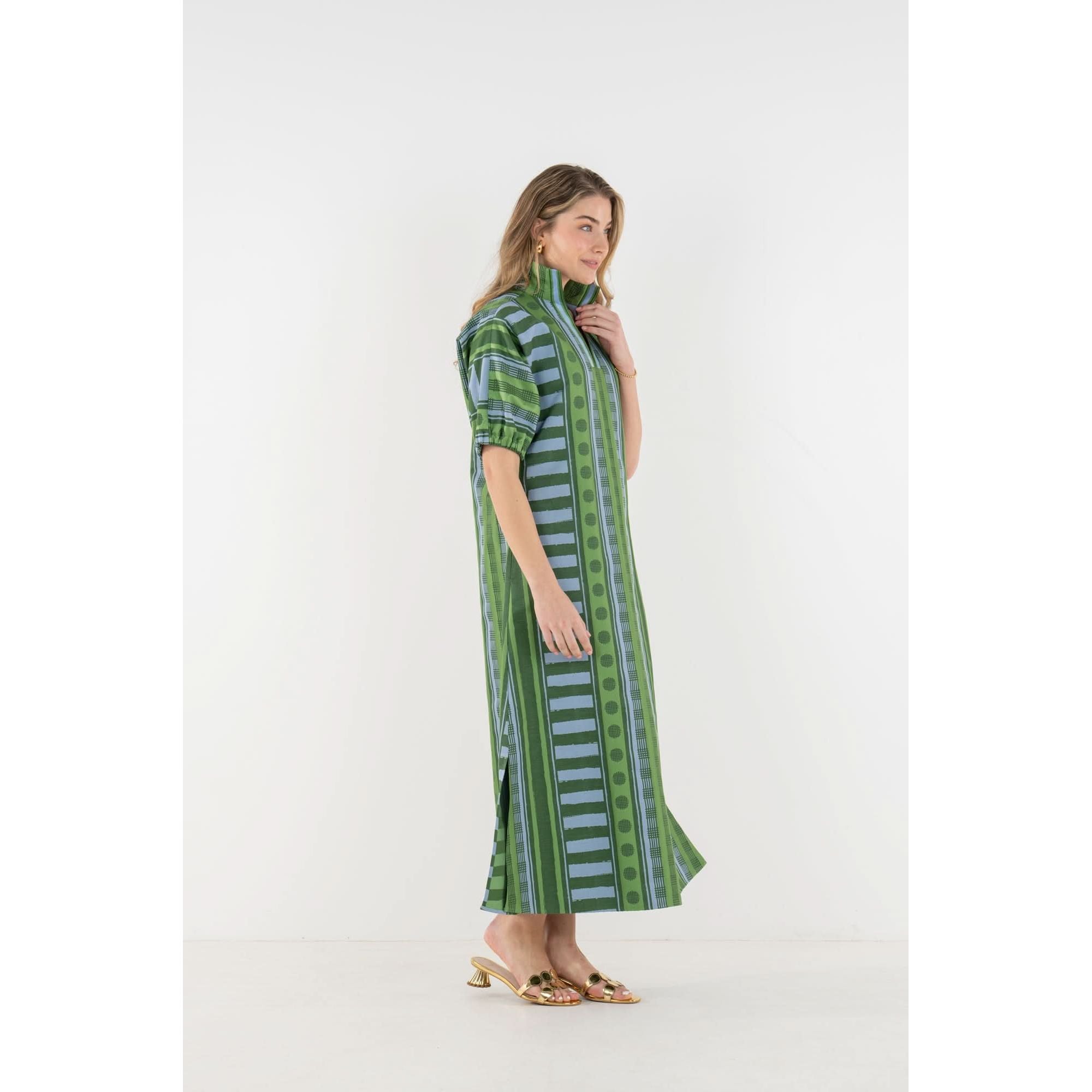 Emily McCarthy Poppy Maxi Forest Jubilee dress featuring a flowing design with floral patterns and vibrant forest-inspired colors.