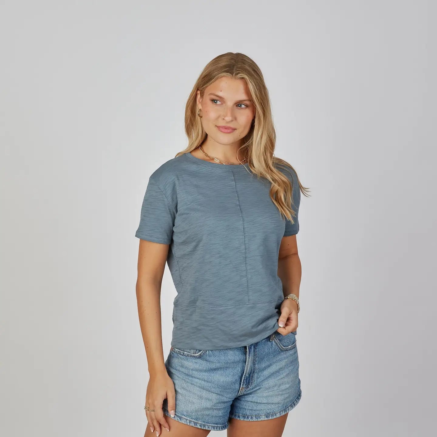 erin gray Celia Perfect Length Tee in denim blue, short sleeve, center seam detail, three-quarter view