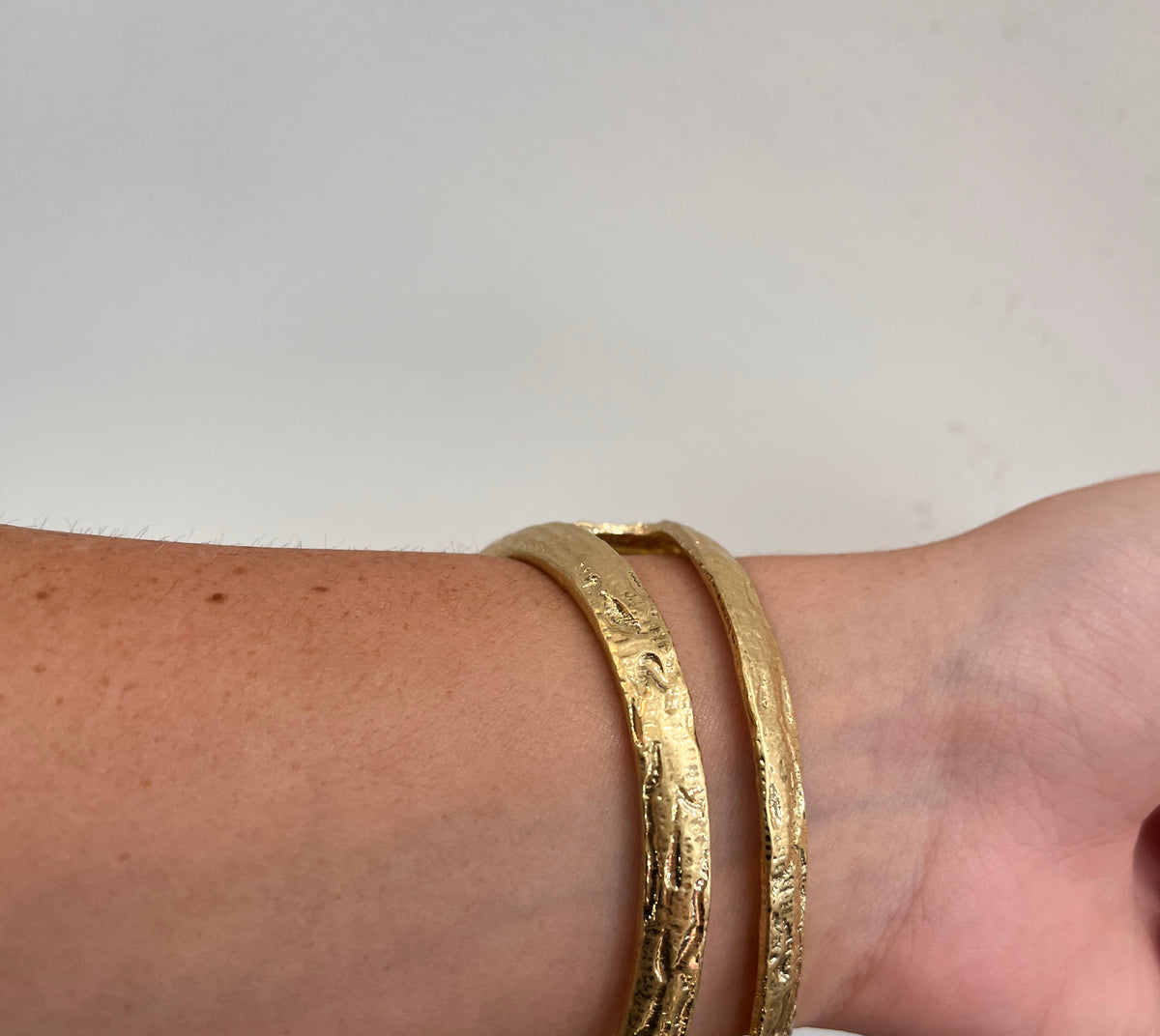 textured gold cuff bracelet with rose shaped flower