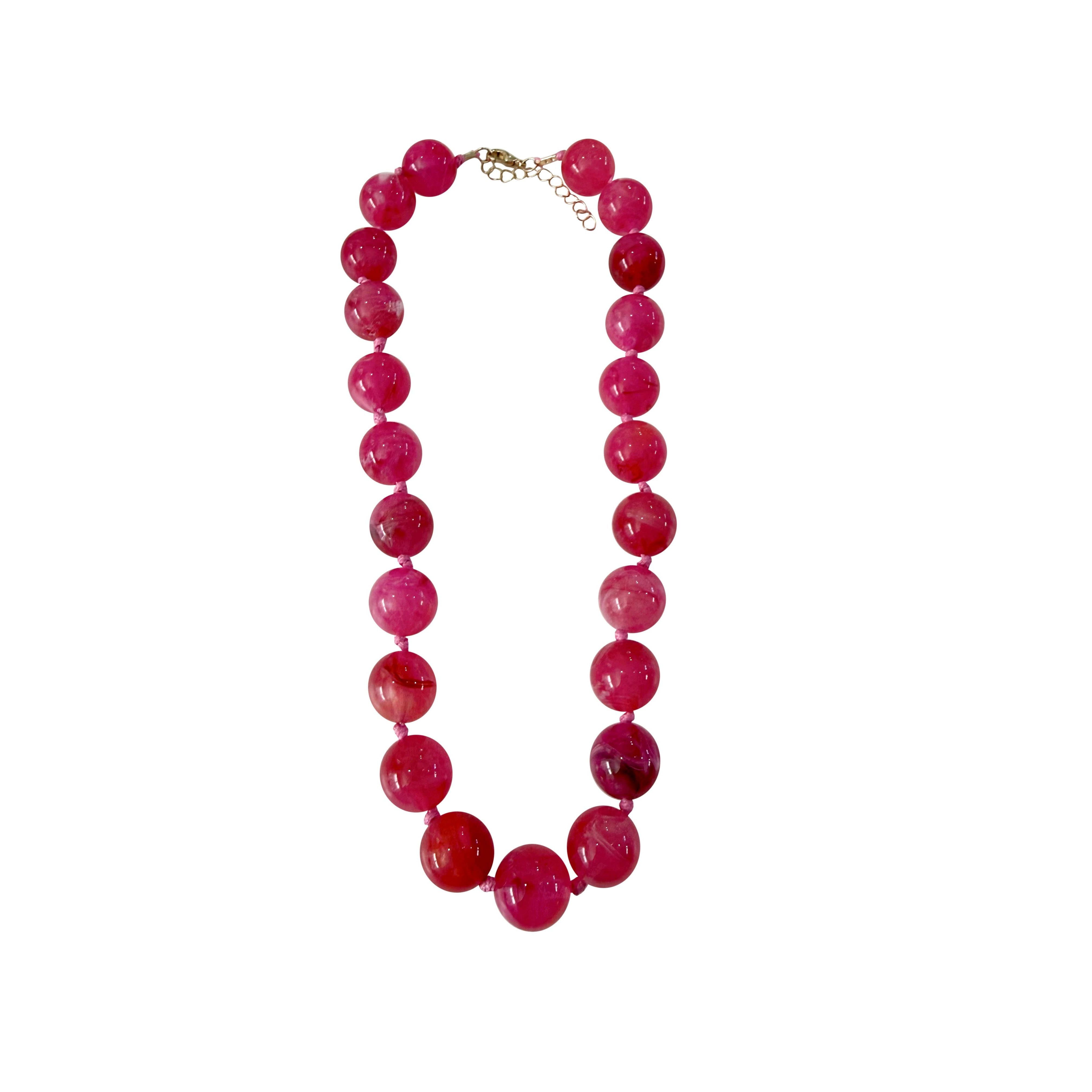 Hot pink Mabry chunky beaded necklace by Gemelli, featuring large colorful beads and a stylish jewelry design.