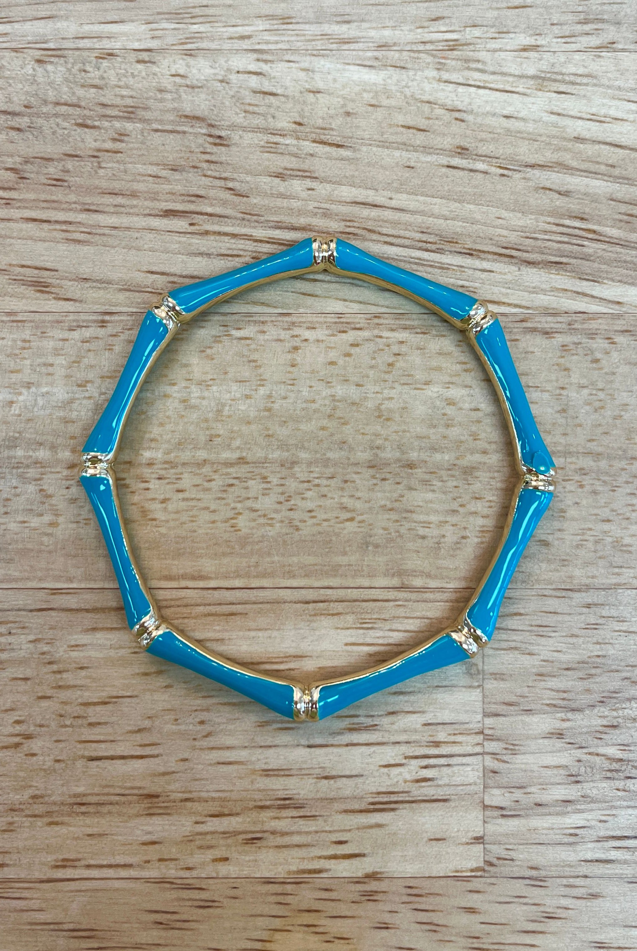 Sm Style bamboo bangle jewelry, natural light-colored wooden bracelet with smooth finish and minimalist design, close-up shot.