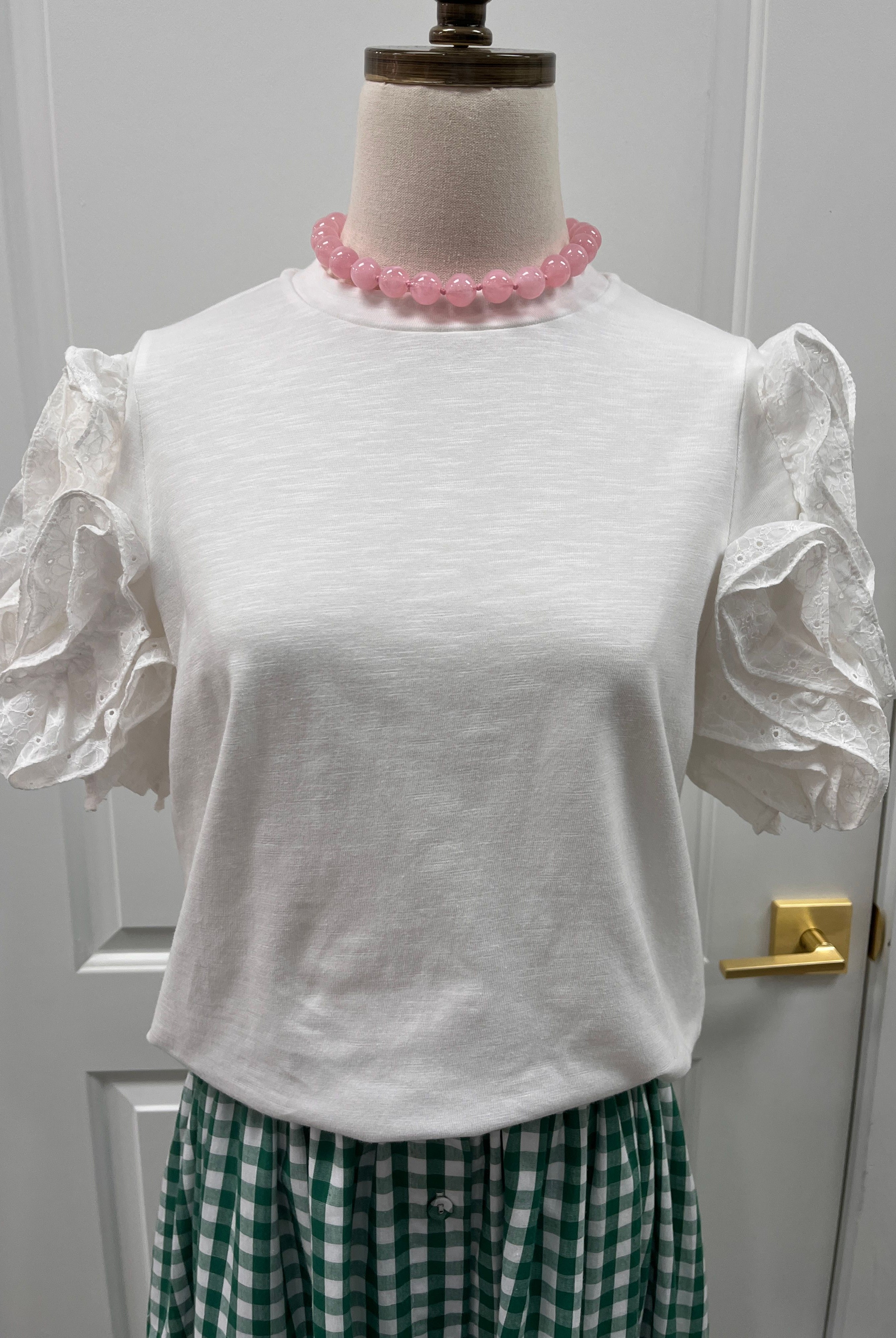 Fate Leigh Top, stylish women's sleeveless blouse in soft fabric with a v-neck and subtle detailing, photographed on a hanger.