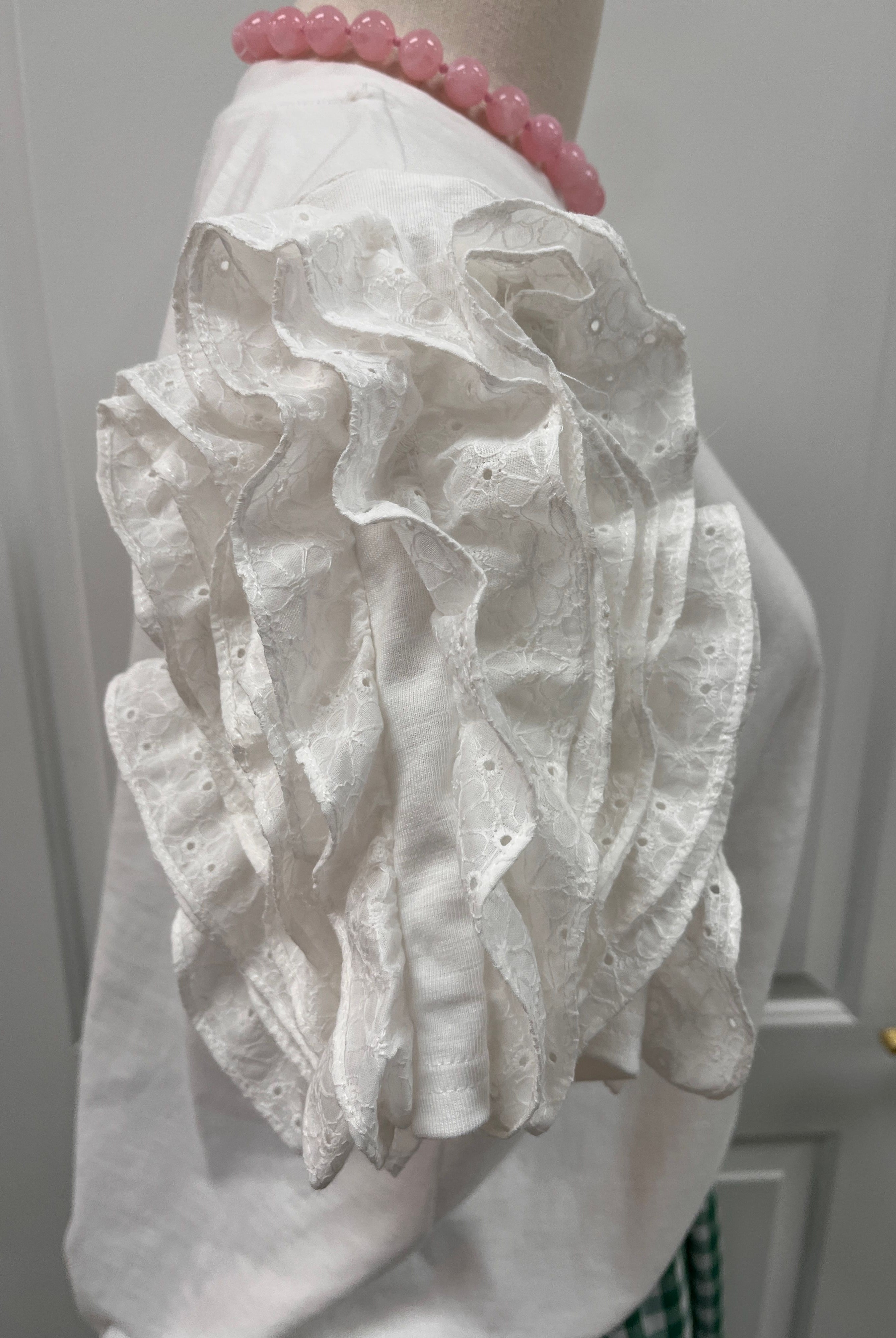 Fate Leigh Top shown in a stylish, fitted design with a V-neckline, featuring soft fabric and a modern, casual silhouette.