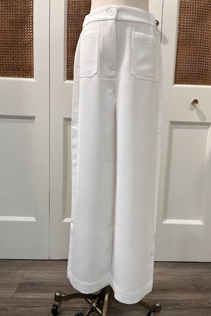 JADE Agnes Pants, stylish women's bottoms with a relaxed fit and neutral color, shown on a model in a casual setting.