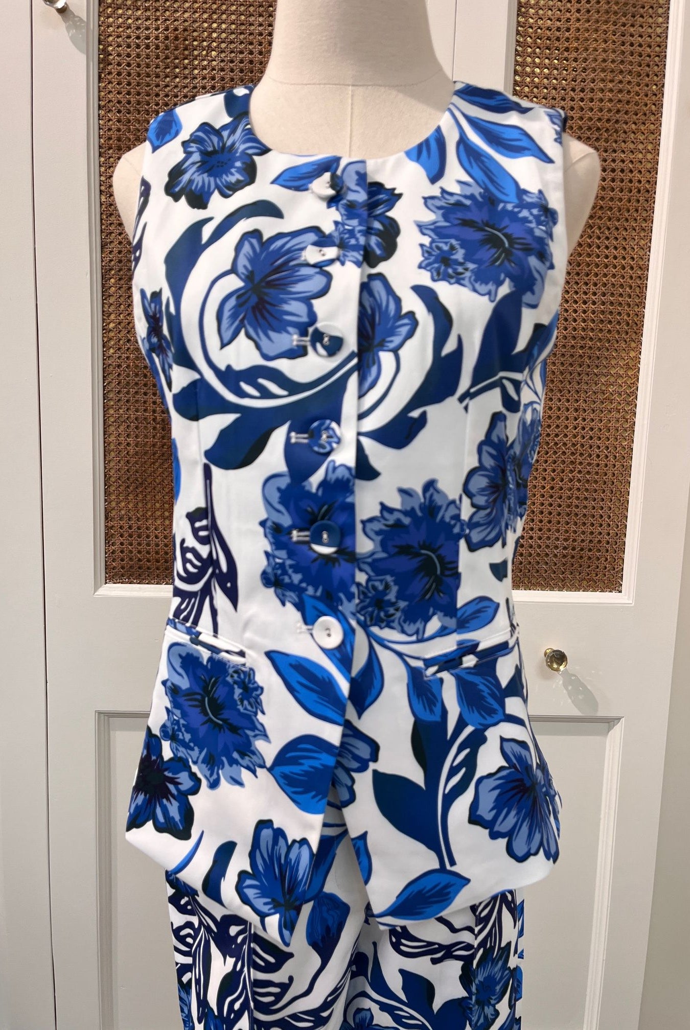 JADE Gladys top, stylish women's sleeveless blouse in vibrant fabric, displayed on a hanger.