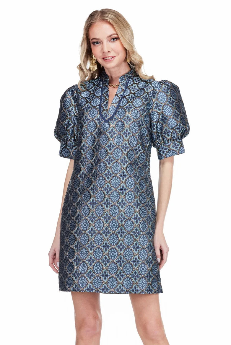 Georgia Dress by Jade in Gilded Trellis, front view, blue and gold metallic trellis jacquard, stand collar V-notch neckline trimmed in navy, puff sleeves, A-line shift silhouette