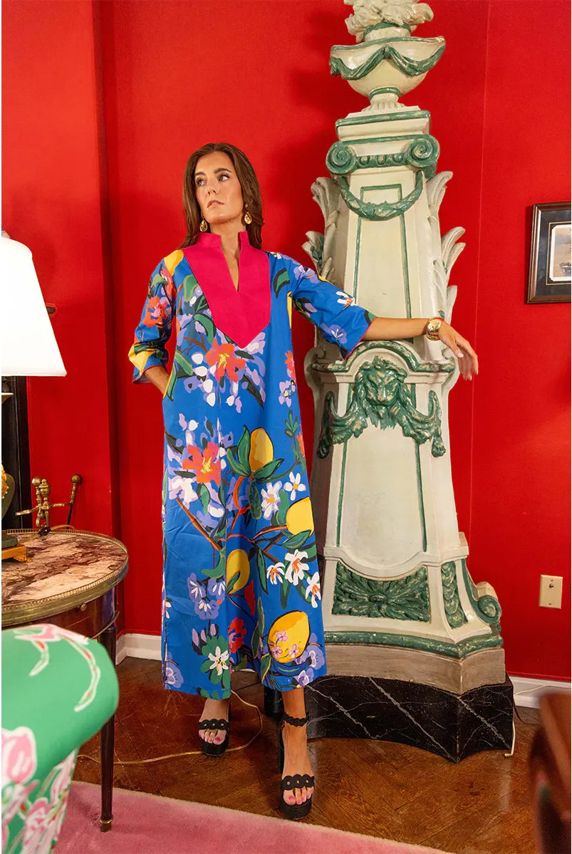 Blue Veranda Babs Dress by House of MBR, displayed on a hanger showing its flowing fabric and vibrant color.