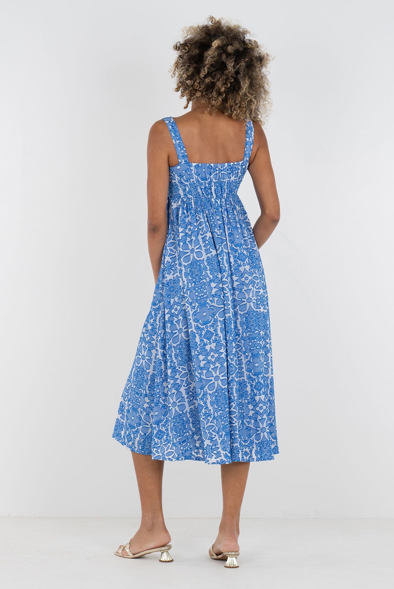 Emily McCarthy Capri dress with a flowy design, featuring a bright, patterned fabric and a back view in a Positano-inspired style.