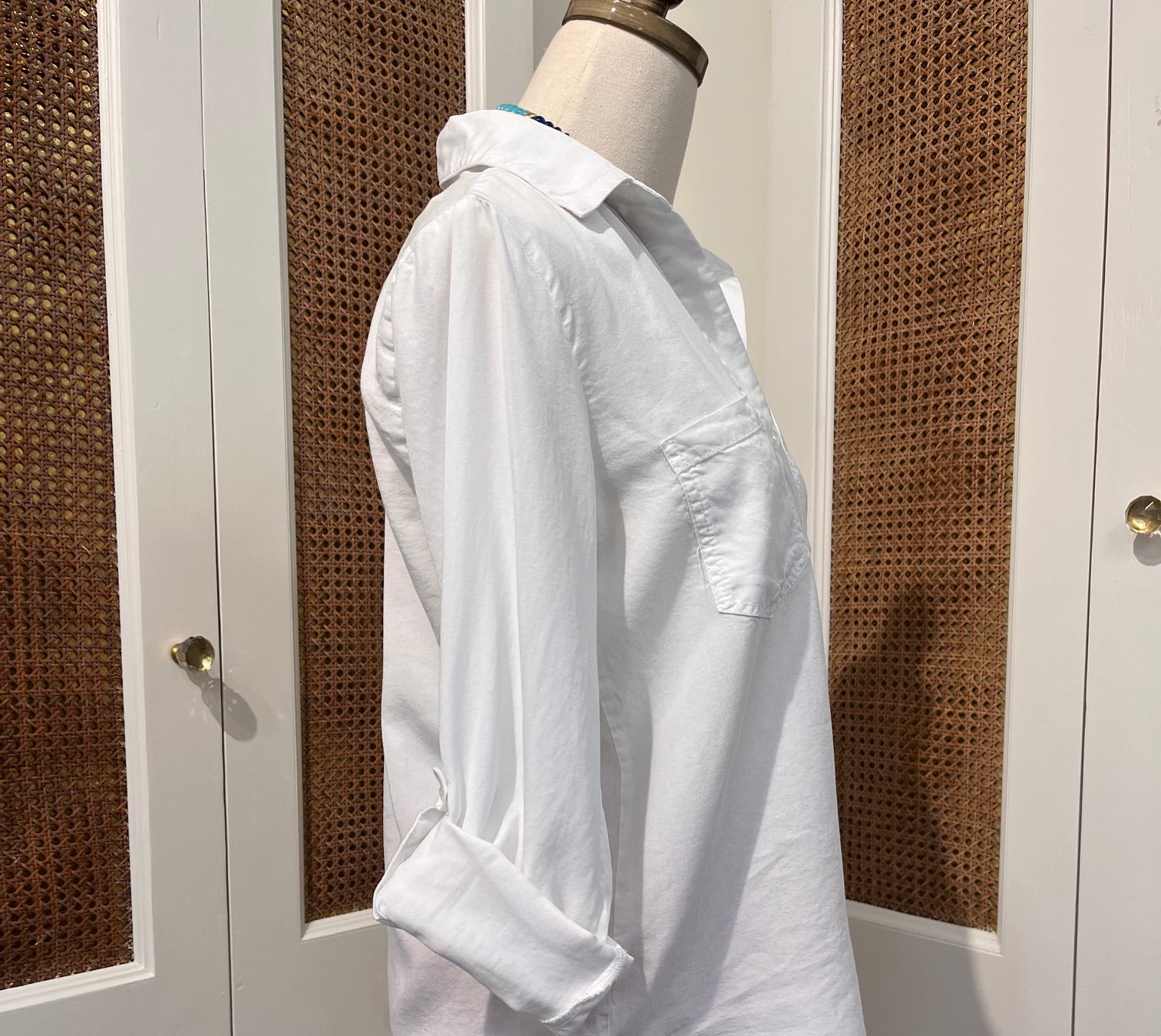 Sirena Top by Velvet Heart — side view of white Tencel button-front shirt with rolled tab sleeves and high-low shirttail hem