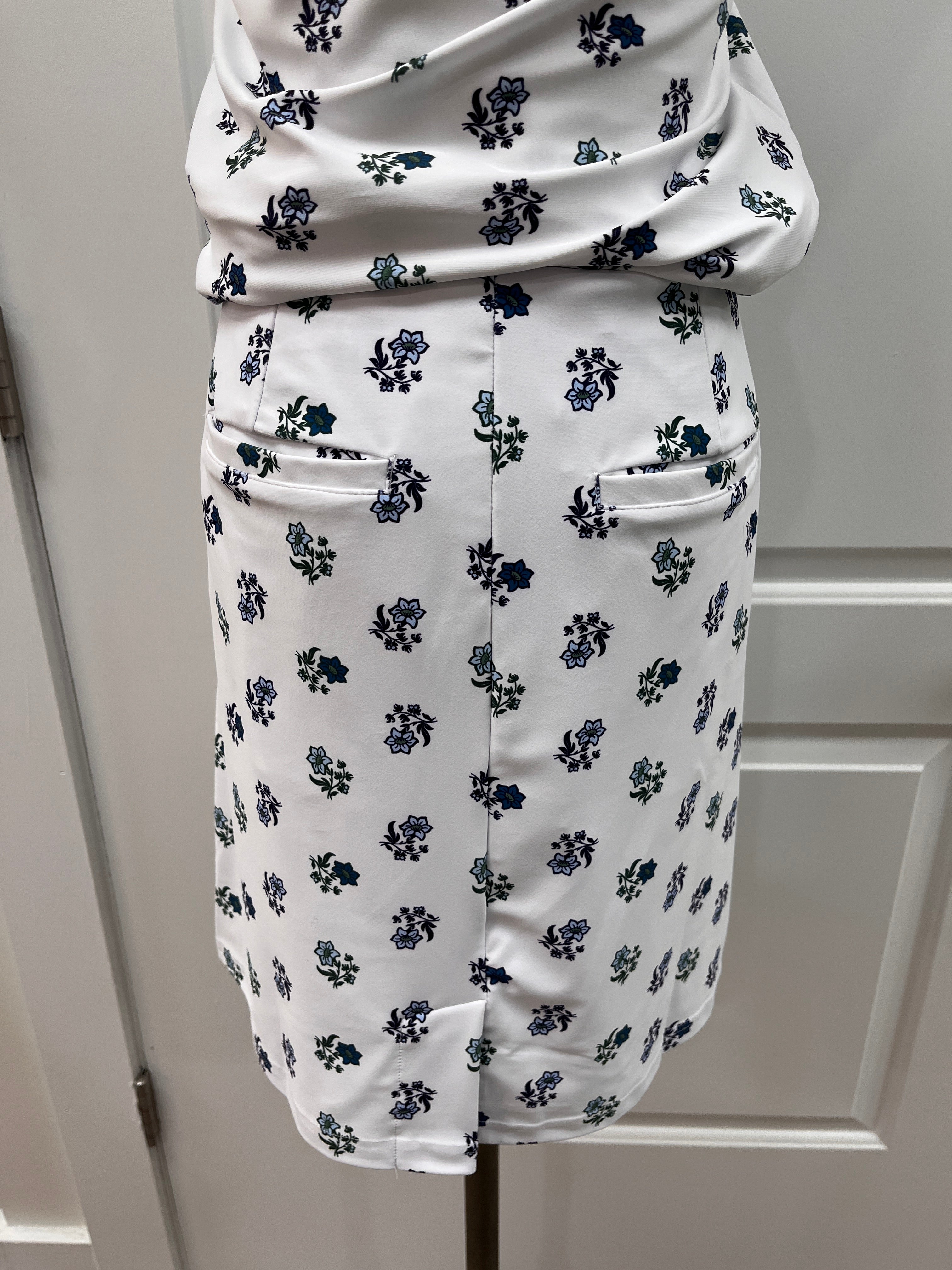 A white fabric-covered cylindrical support or handle with a repeating navy blue floral pattern, shown against a white paneled background.