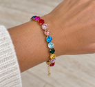 Rainbow Rhinestone Bracelet by Marj & Lizzie, multicolor rhinestones in gold bezels with extender chain, worn on wrist