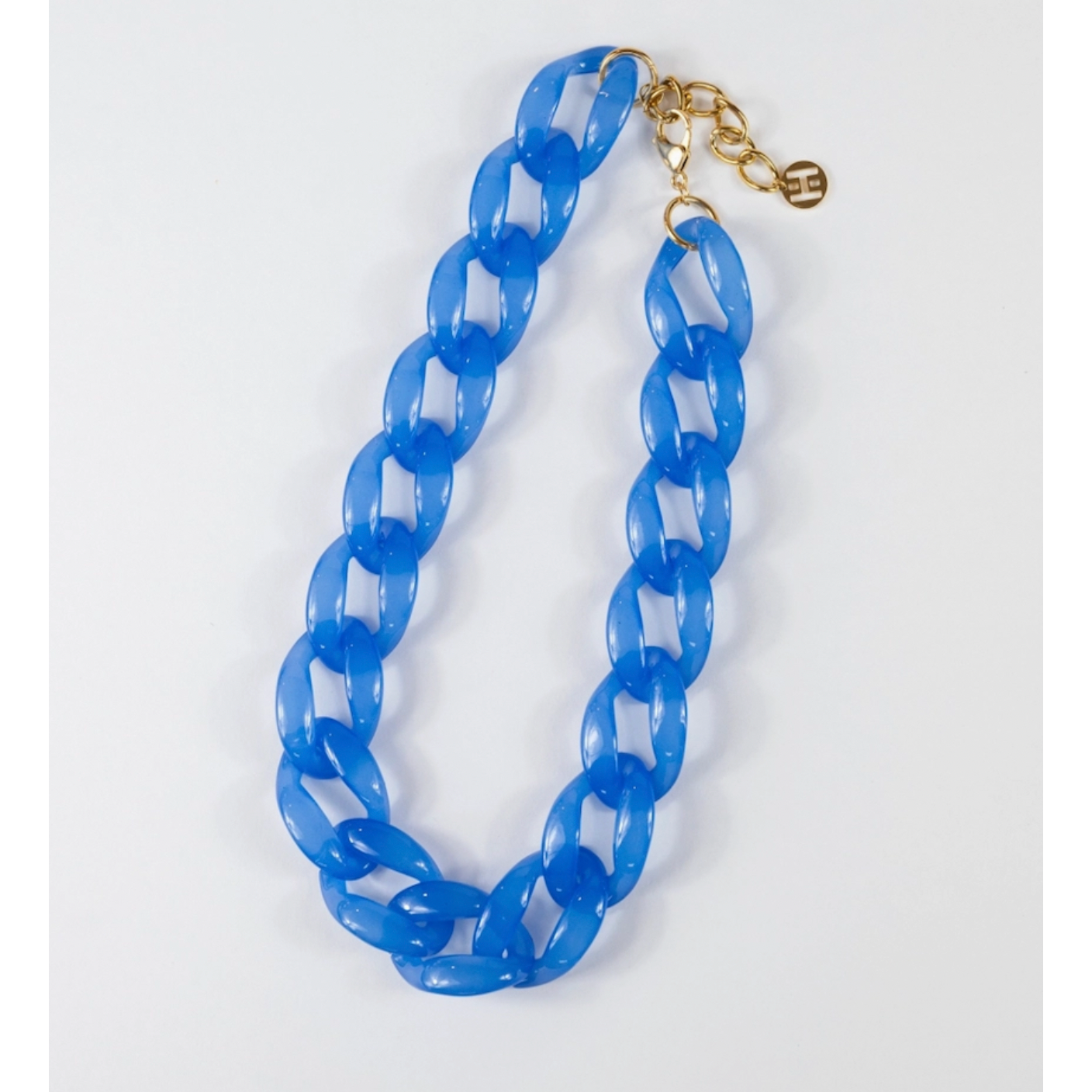 Blue chain necklace with a gold clasp on a white background