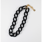 Black chain necklace with a gold clasp on a white background