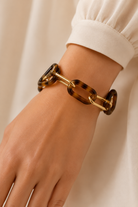 Tortoise Double Link Bracelet by Ali Bird worn on wrist, alternating tortoise resin and gold chain links