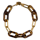 Tortoise Double Link Bracelet by Ali Bird, flat lay, alternating tortoise resin and gold oval links with gold barrel clasp