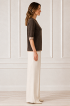 Another Love Dera Top in chocolate brown, crew neck short-sleeve knit with oatmeal cuffs and banded hem, side view