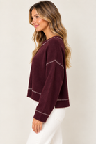 Millie Sweater by Another Love in burgundy with drop shoulders, long sleeves and contrast embroidery, side view