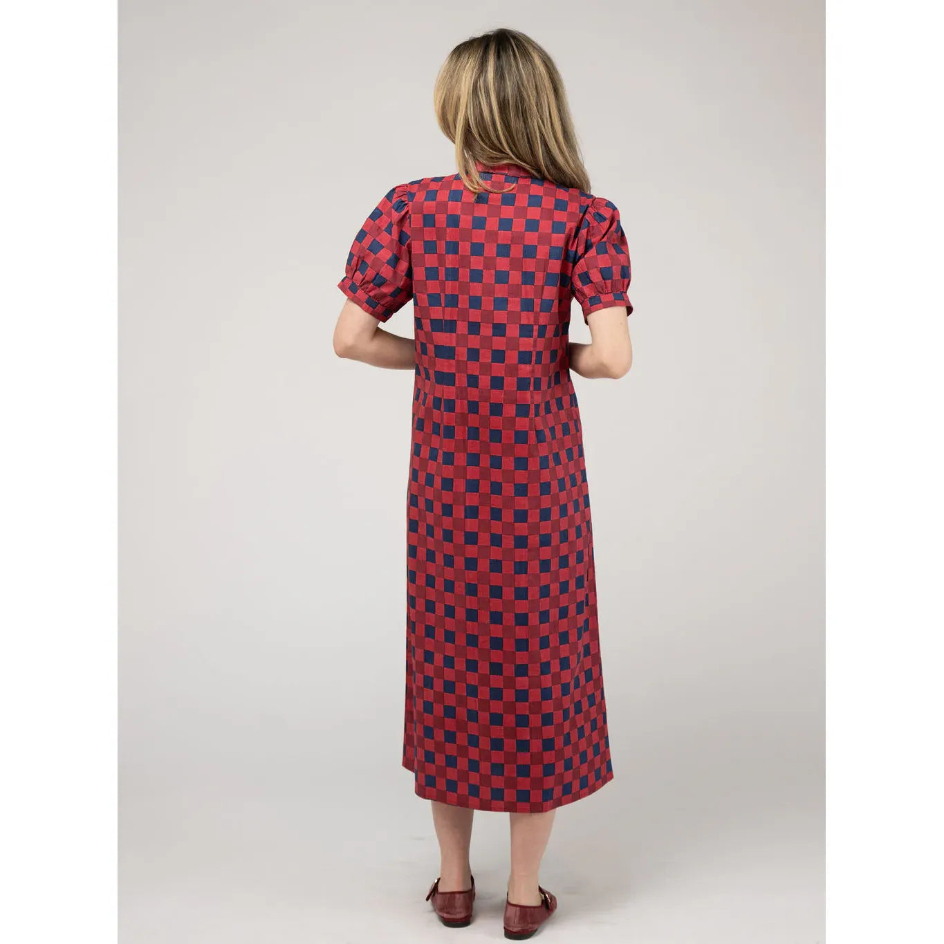 Back view of the Beau & Ro Kris Dress in cranberry check fabric, featuring a stylish and comfortable dress design.