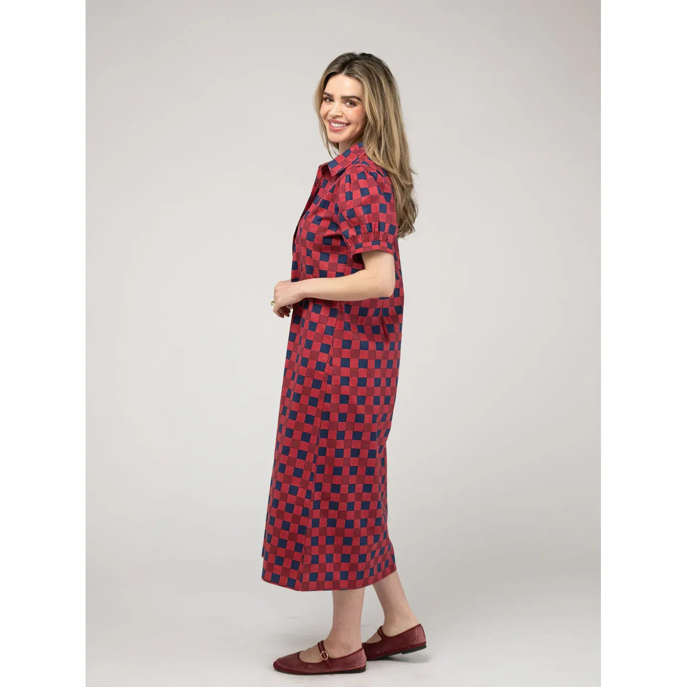 Beau & Ro Kris Cranberry Dress shown from a side view, showcasing its elegant fit and vibrant cranberry color.