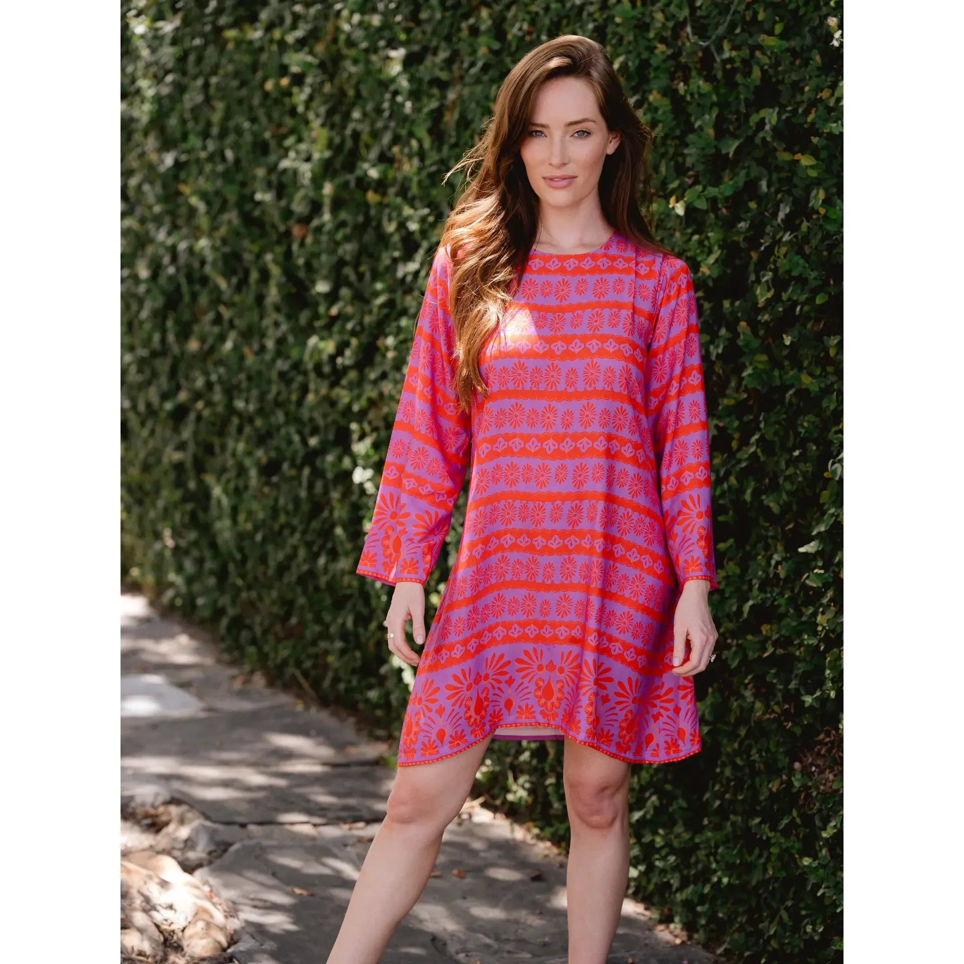 Briton Court Nina Magenta dress displayed on a hanger, showcasing its vibrant magenta color and stylish design.