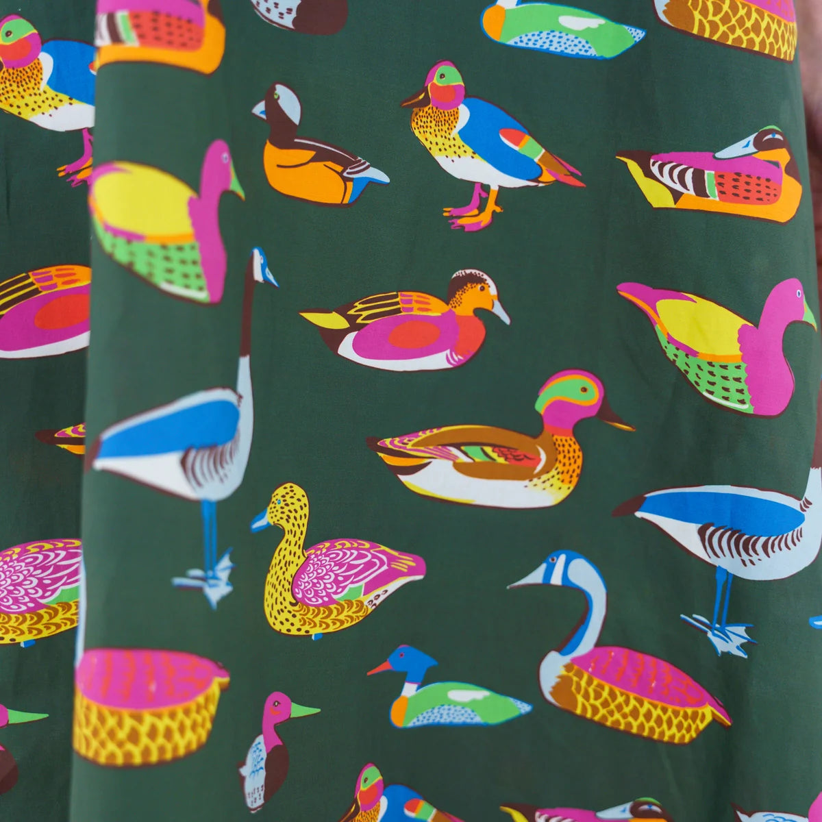 Caryn Lawn Sutton Skirt olive duck print close-up, multicolor illustrated ducks on olive green cotton poplin