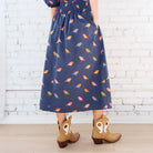 Caryn Lawn Sutton Skirt in navy bird print, gathered midi skirt, smocked waistband, back view