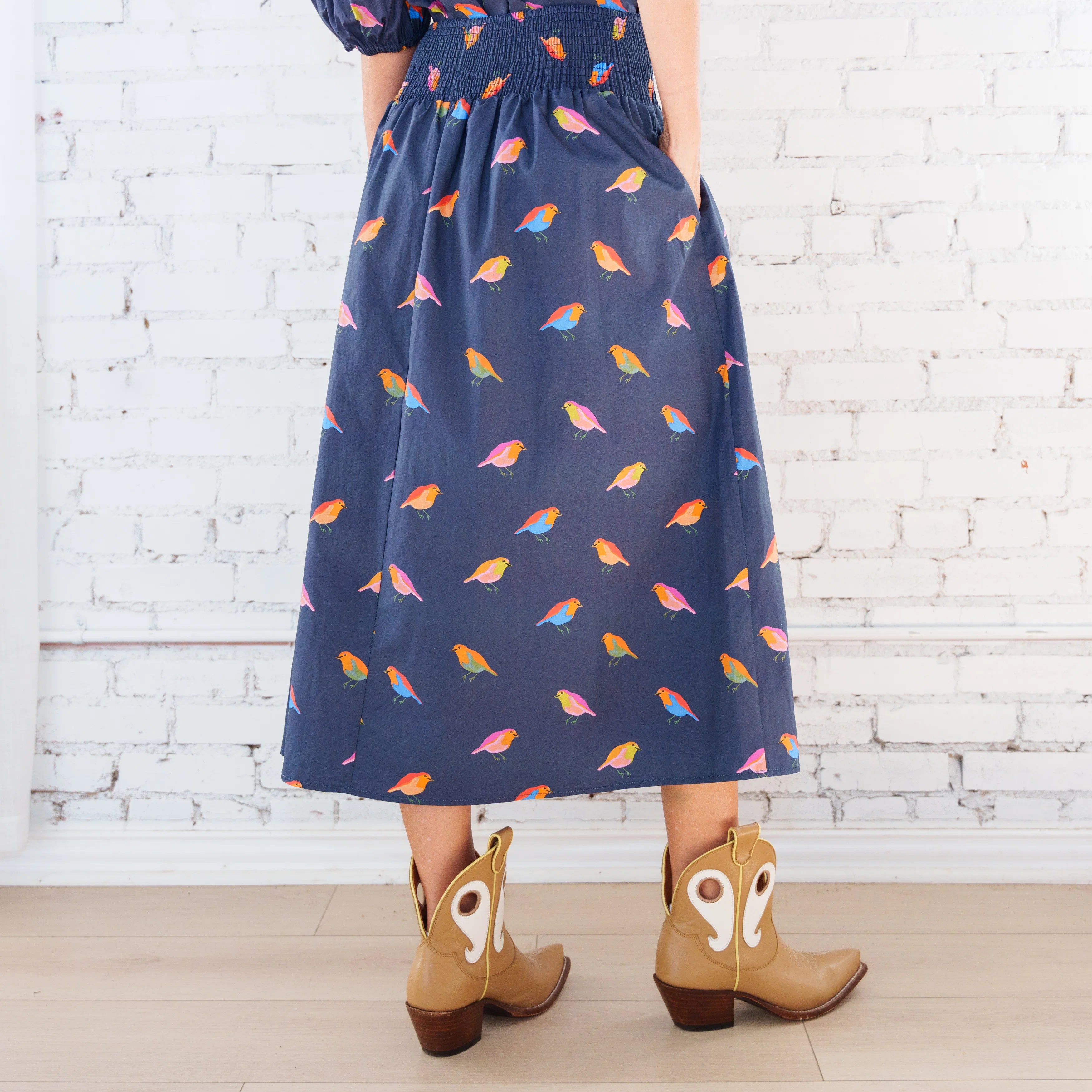 Caryn Lawn Sutton Skirt in navy bird print, gathered midi skirt, smocked waistband, back view