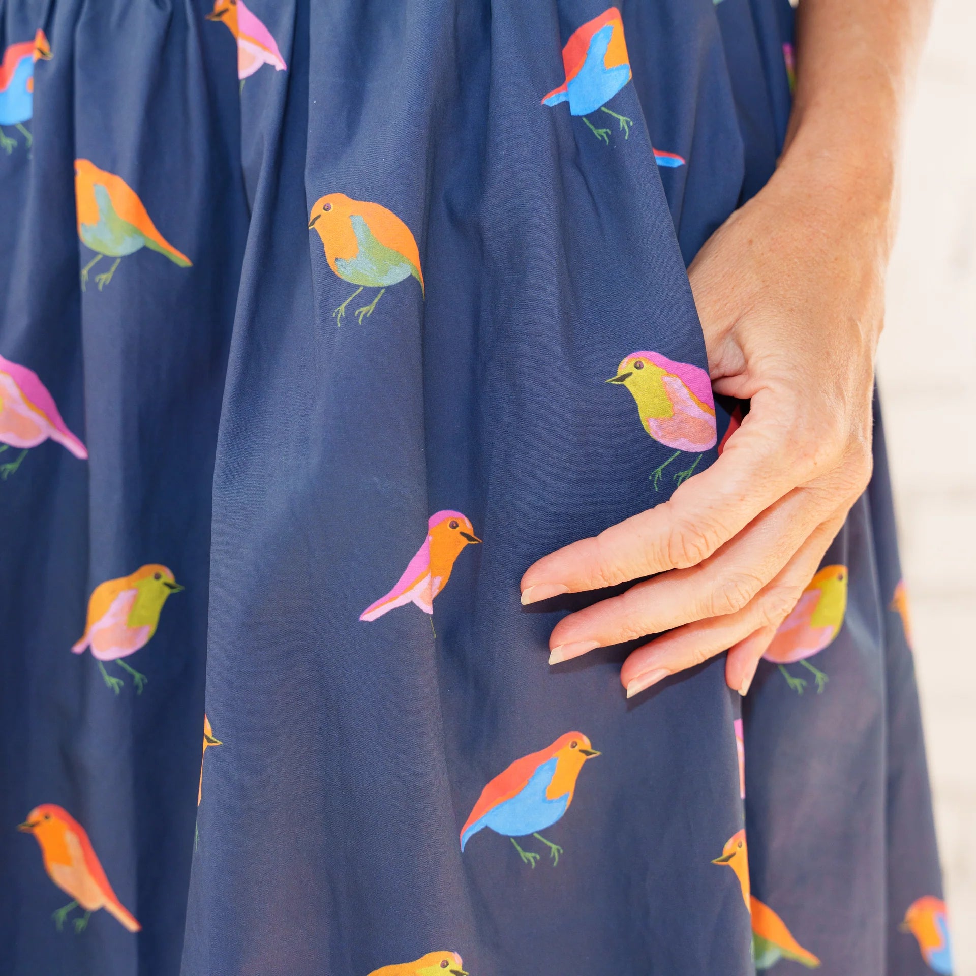 Caryn Lawn Sutton Skirt in navy bird print, multicolor bird print detail, side pocket close-up