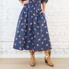 Caryn Lawn Sutton Skirt in navy bird print, gathered midi skirt with side pocket, front close-up view