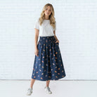 Caryn Lawn Sutton Skirt in navy bird print, full-length midi skirt, elastic waistband, front view