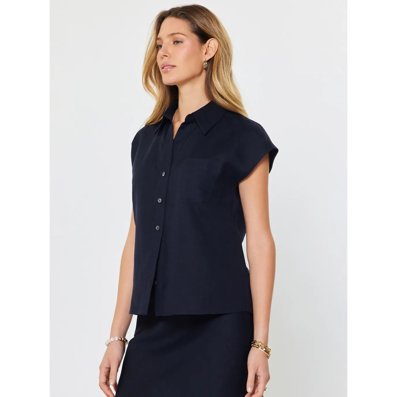 Current Air Lucy Ann top featuring cap sleeves and a button-down design, shown from a side view.