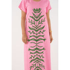 Emily McCarthy Cornelia Dress in Rose, a stylish floral dress with elegant design and vibrant pink color, displayed on a hanger.