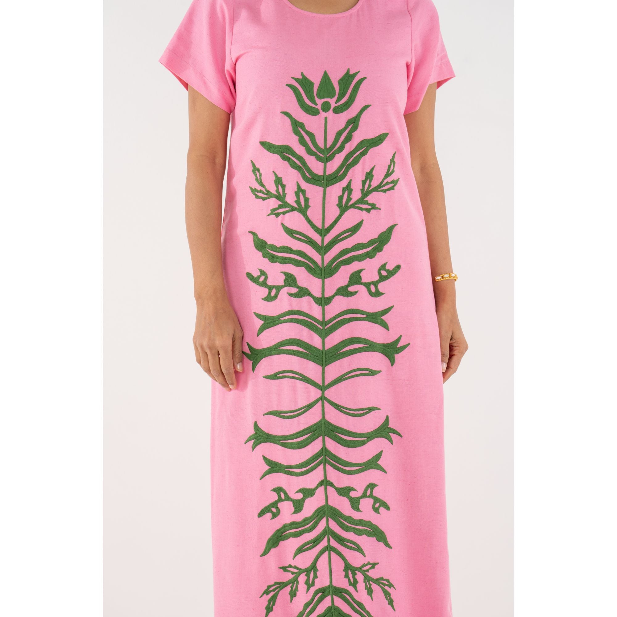 Emily McCarthy Cornelia Dress in Rose, a stylish floral dress with elegant design and vibrant pink color, displayed on a hanger.