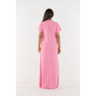 Emily McCarthy Cornelia Dress in Rose, back view showing elegant floral pattern and flowing fabric.