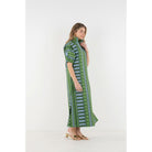 Emily McCarthy Poppy Maxi Forest Jubilee dress featuring a flowing design with floral patterns and vibrant forest-inspired colors.