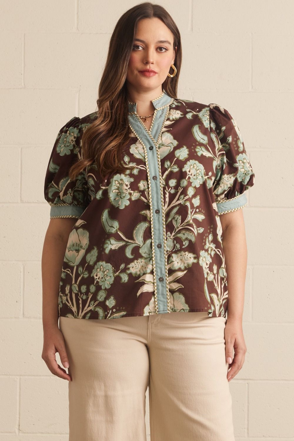 Entro Mabel Top in chocolate brown botanical floral print, button-front V-neck with powder blue contrast binding and short puff sleeves, front view