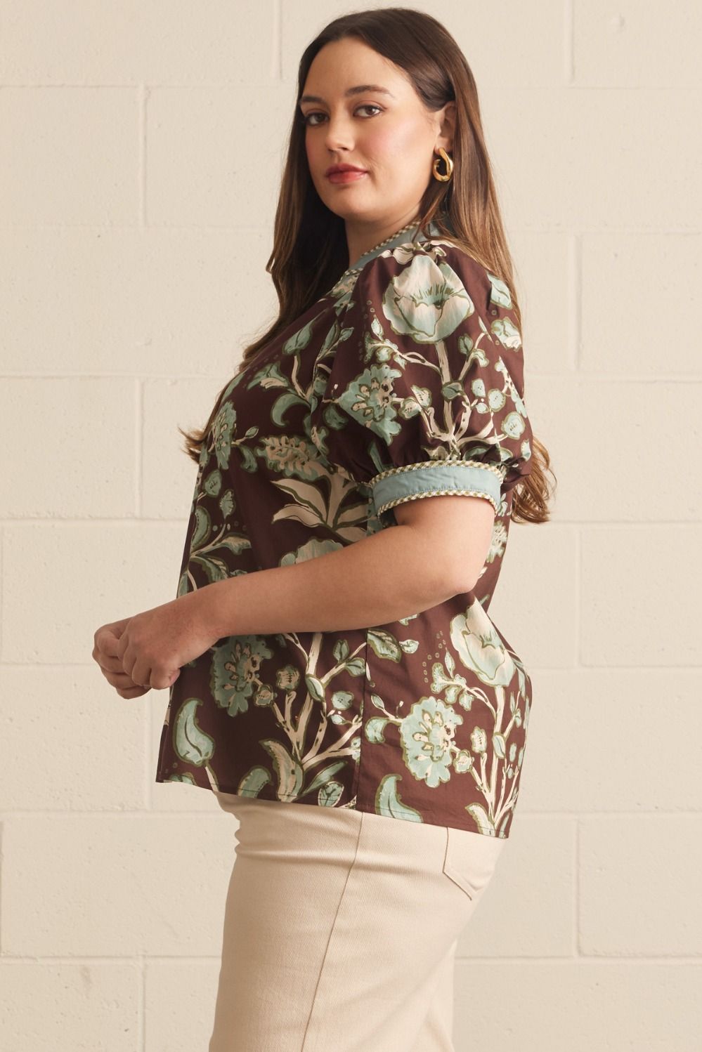 Entro Mabel Top in chocolate brown botanical floral print, short puff sleeves with powder blue contrast cuffs, relaxed silhouette, side view