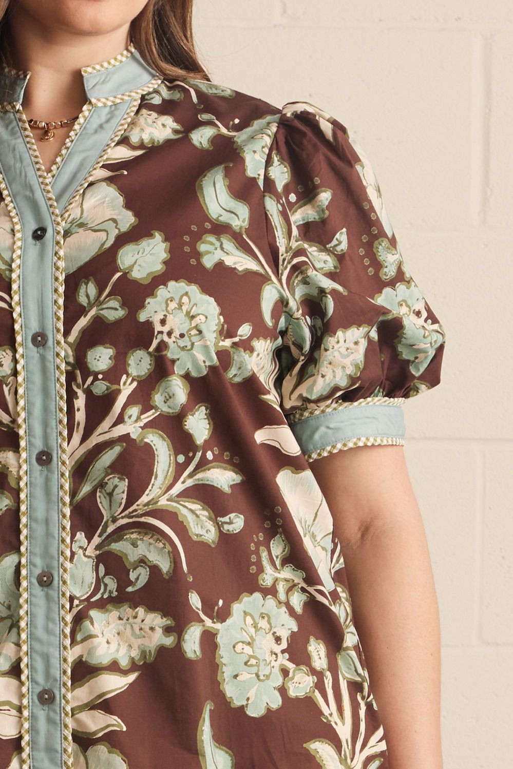 Entro Mabel Top close-up detail showing braided trim on powder blue contrast binding, V-neckline, and button placket
Style#T32339