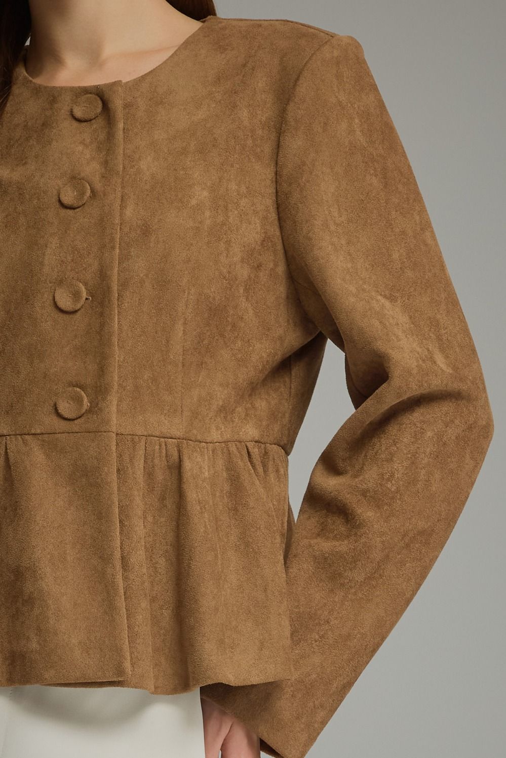 Ellery Top by Entro in mocha brown, close-up of round neckline, fabric-covered buttons and gathered peplum hem