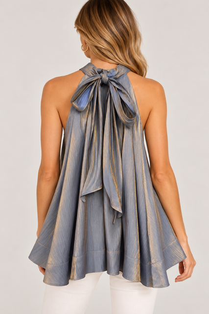 Ainsley Top by Fate in metallic silver-gray with a large tie-back bow, trailing ties, and flared hem, back view.